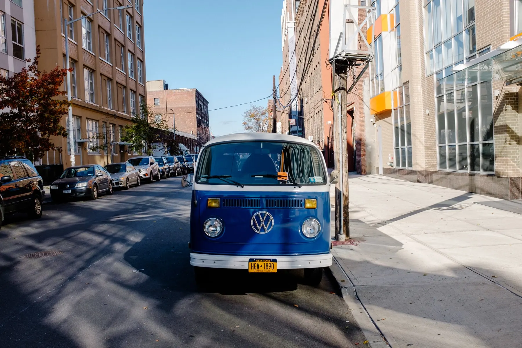 Blue VW camper van parked at a street corner