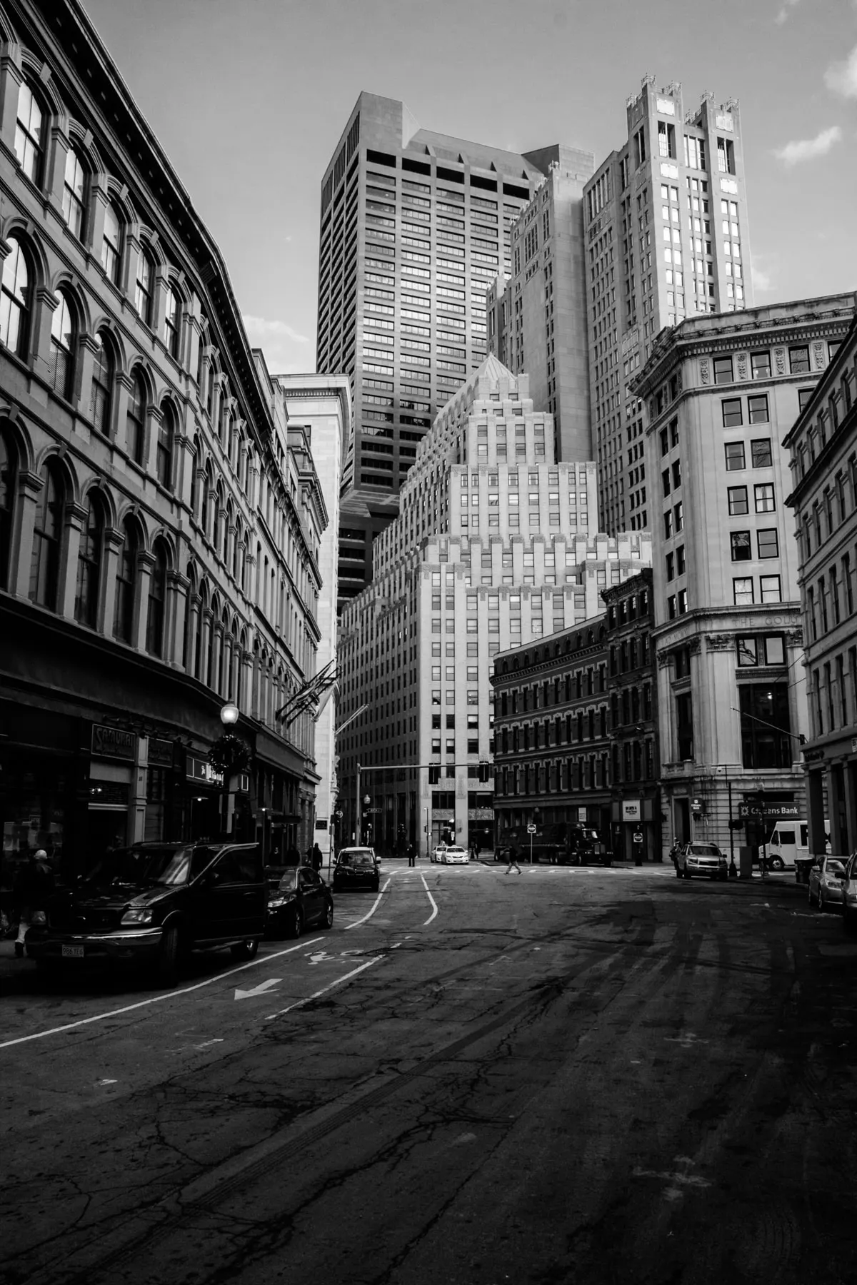 Empty street between old brick and stone buildings